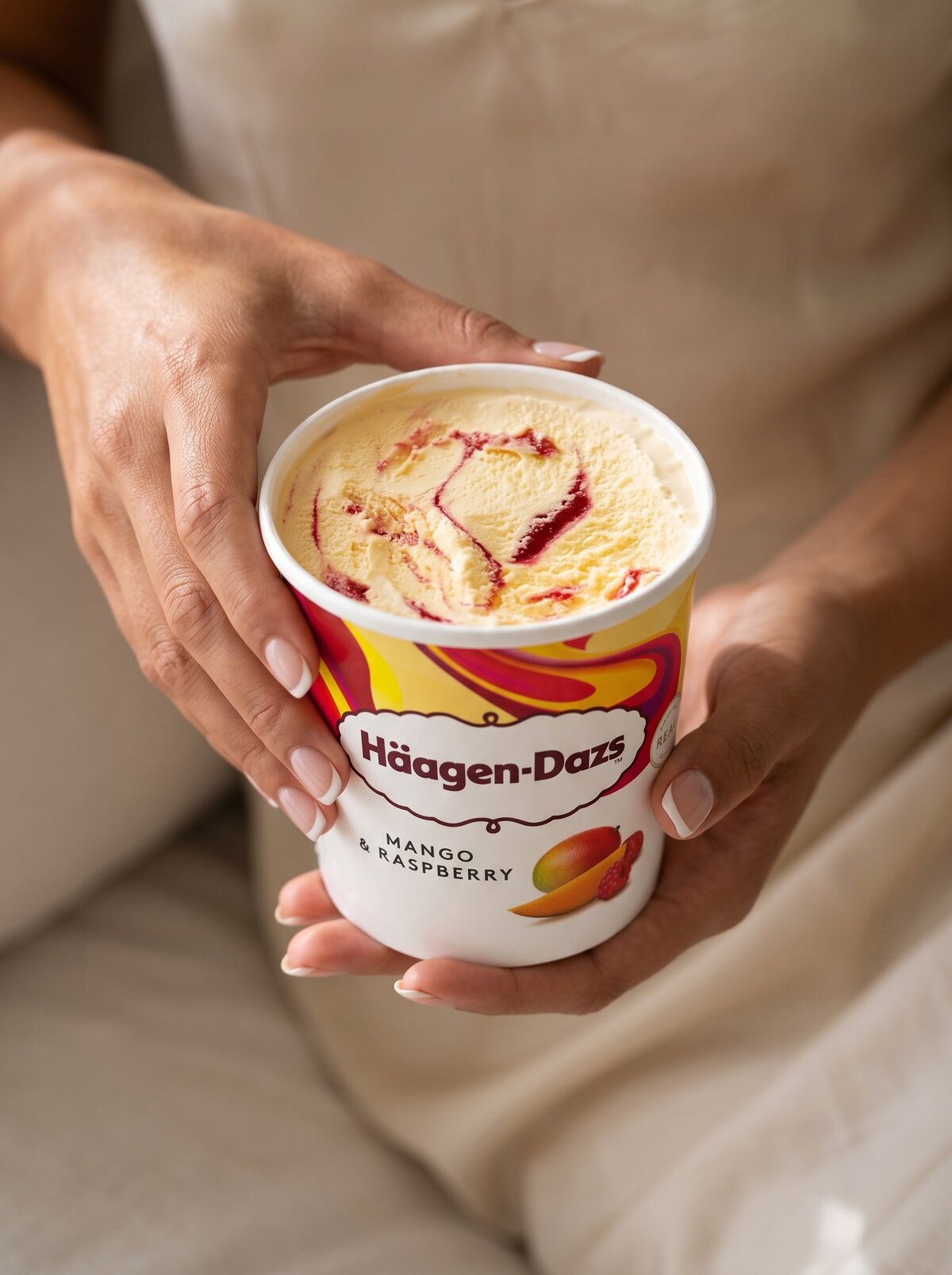 Haagen-Dazs Mango Raspberry, held in hand, lifestyle
