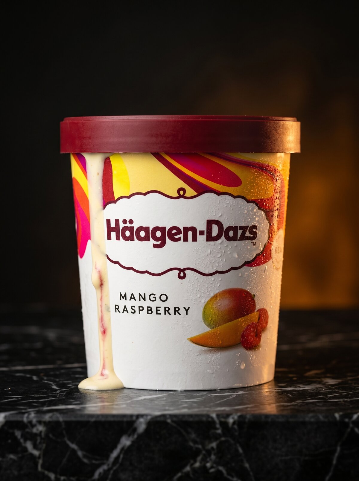 Haagen-Dazs Mango Raspberry, hero product shot, dark background