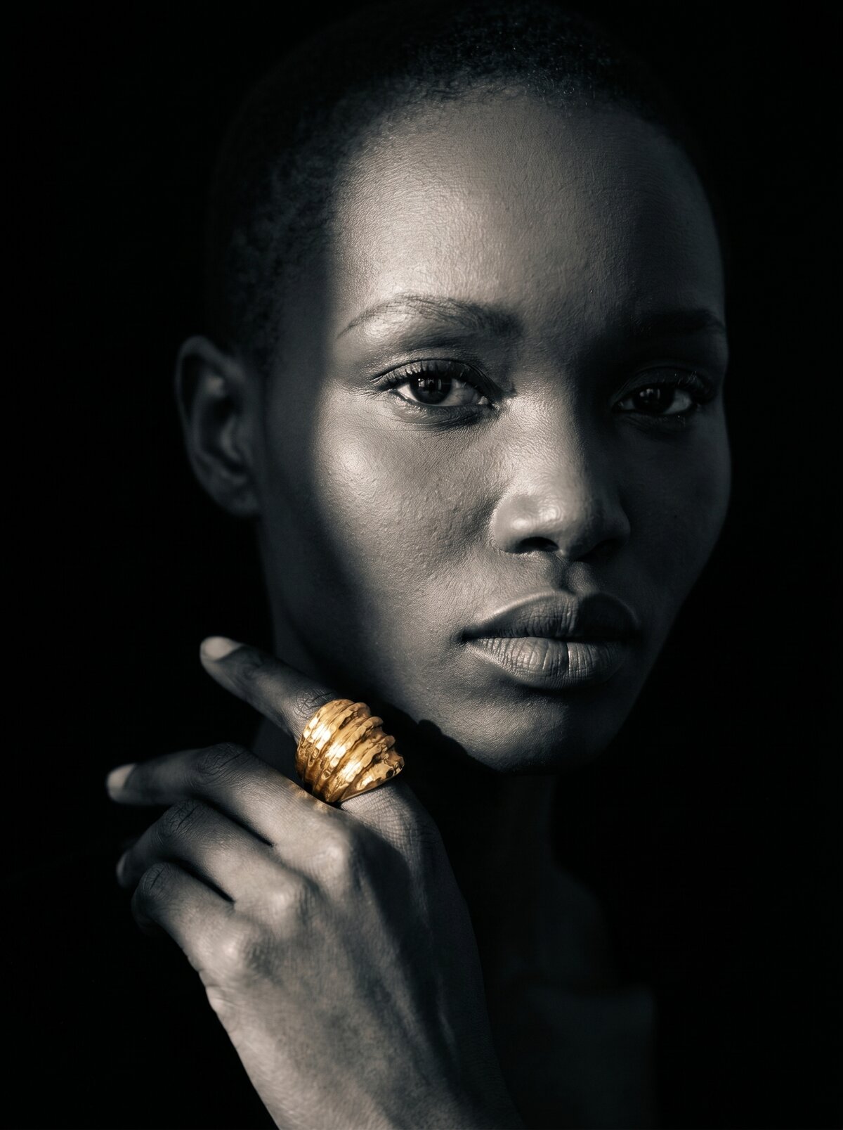 Gilded, black and white portrait, ring at the face